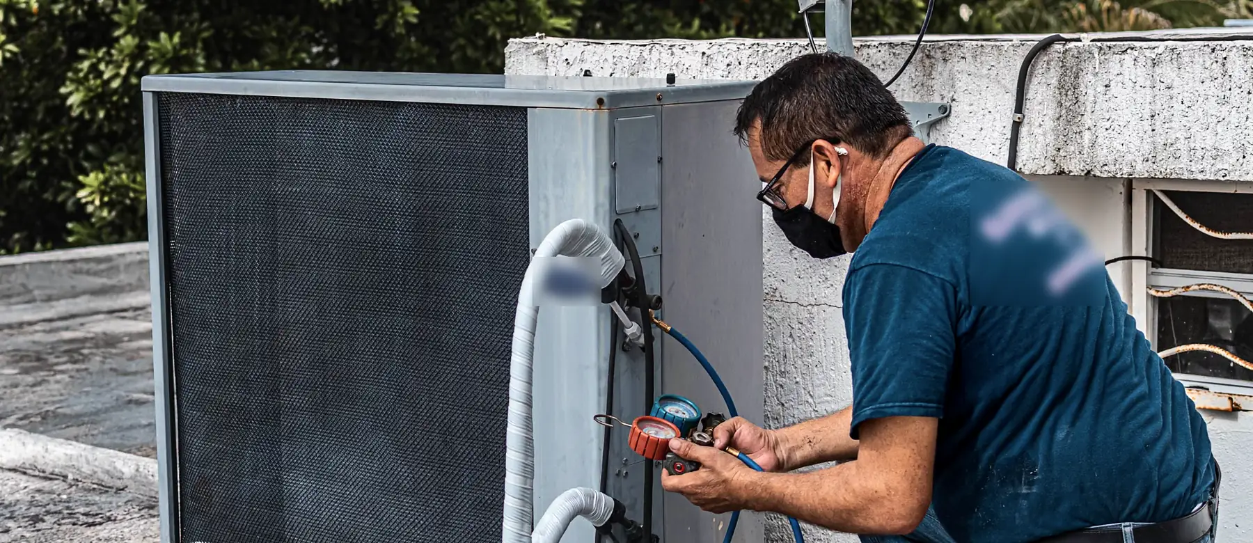 HVAC technician checking refrigerant pressure on an outdoor condenser unit