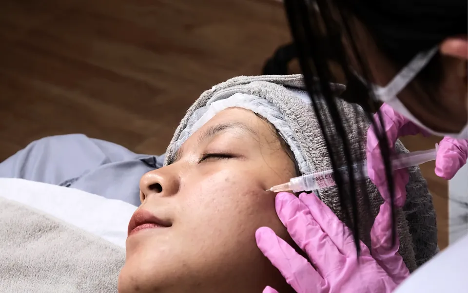 Practitioner performing a facial treatment on a client in a med spa