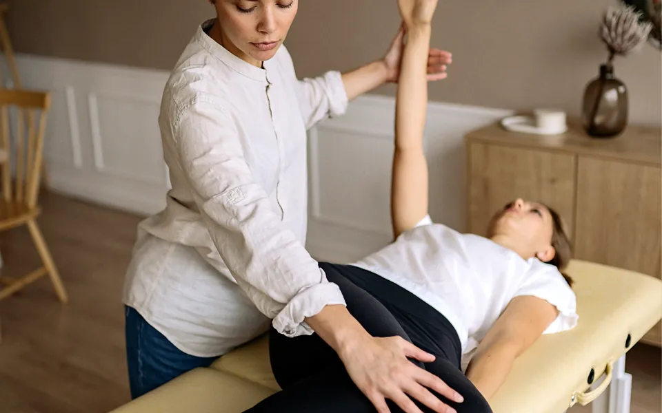 Physical therapist guiding a patient through a stretching exercise