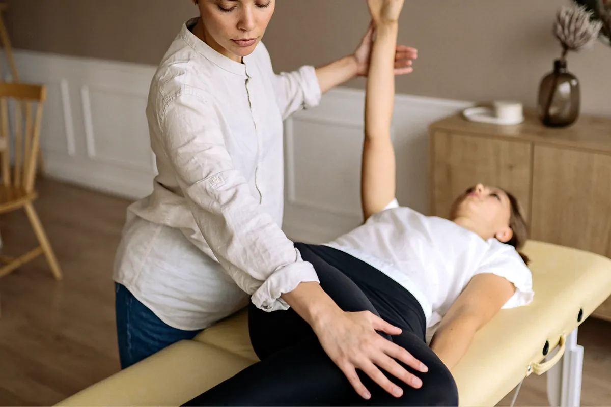 Physical therapist guiding a patient through a stretching exercise