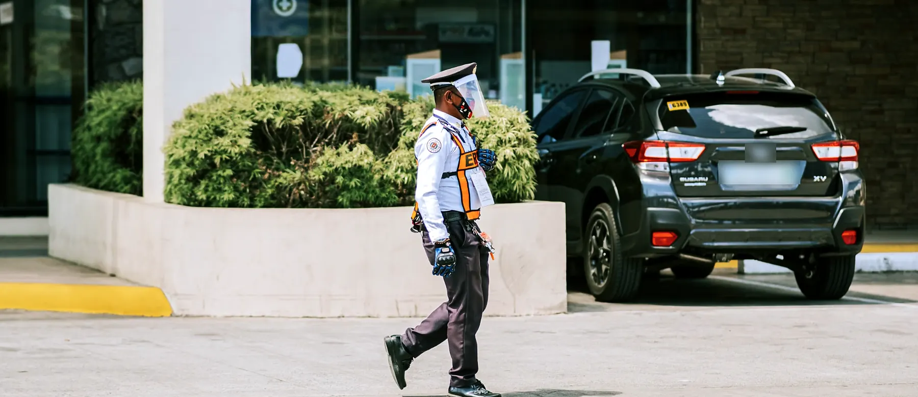 Uniformed security officer on patrol outside a commercial building