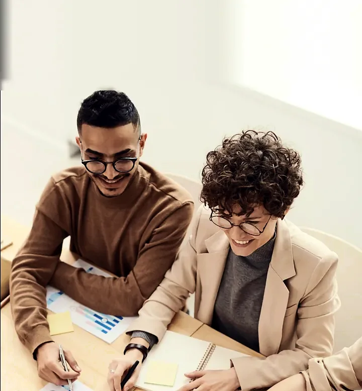 Two business owners reviewing financial reports together